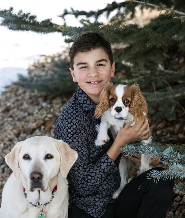On the positive side of things, now is a great time to hunker down and have some family time. With schools closed until at least May, we will be doing just that!😀🐶❤️
​
​In this photo, Danelle's son, Brocton, is smiling with Aziza and Windy (in hand).