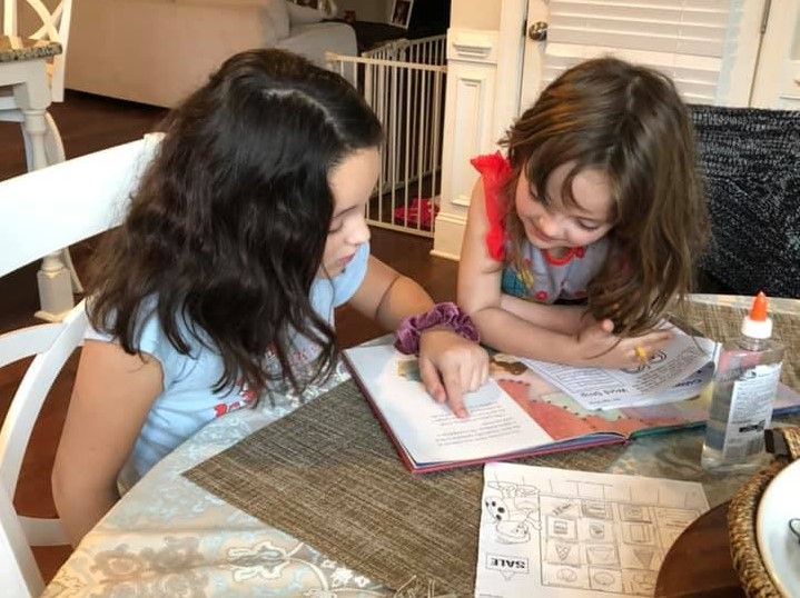 StMSCary's tweet photo. This small act of kindness -big sister helping little sister - is sure to please the heart of God this Lent. How is your Lenten Journey progressing? #Almsgiving #Lent #StMSDistanceLearning https://t.co/vBXMaFi7vM