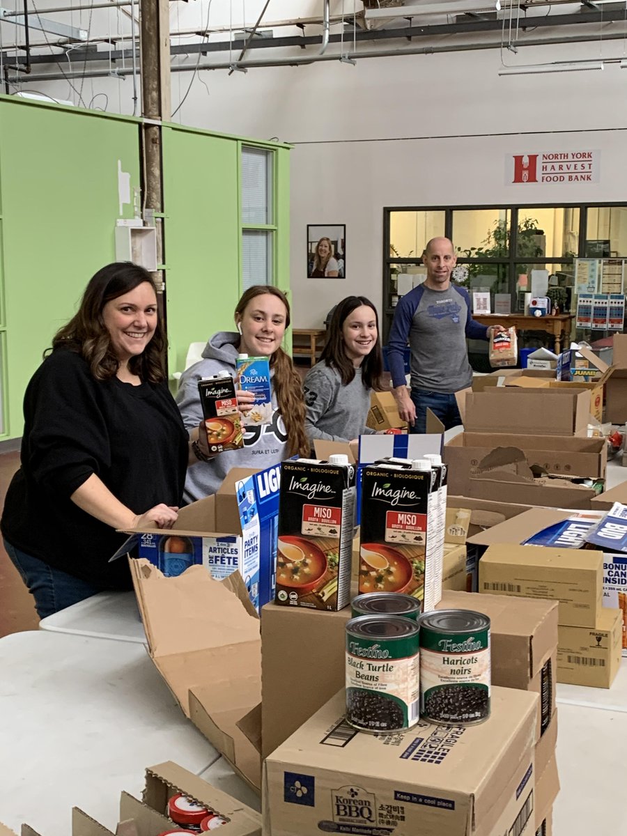 ryanT_noble's tweet photo. It may not be Santa's workshop but we have all hands on deck @nyhfb. Board member @CarmMcCormick and family pre-packing hampers for clients at the Bathurst-Finch Community Food Bank. #TogetherTO https://t.co/MmizB5hpkU