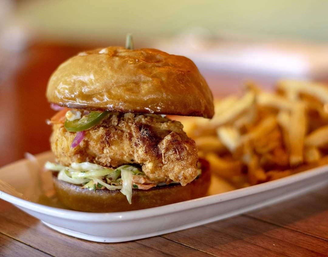 Lunch couldn’t taste any better! 
Crispy Chicken Sandwich with piquillo aioli, citrus mustard slaw and spicy pickled peppers.