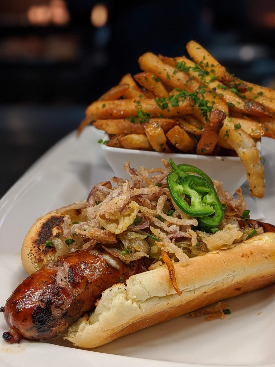 RoyalPigPub's tweet photo. ☘️  #Bratwurst on a Bun with mustard aioli, fried shallots topped with jalapeño served with parmesan truffle fries! Enjoy this pub favorite or #BangersandMash on Friday and Saturday, while they last! https://t.co/zJptFVO4cD