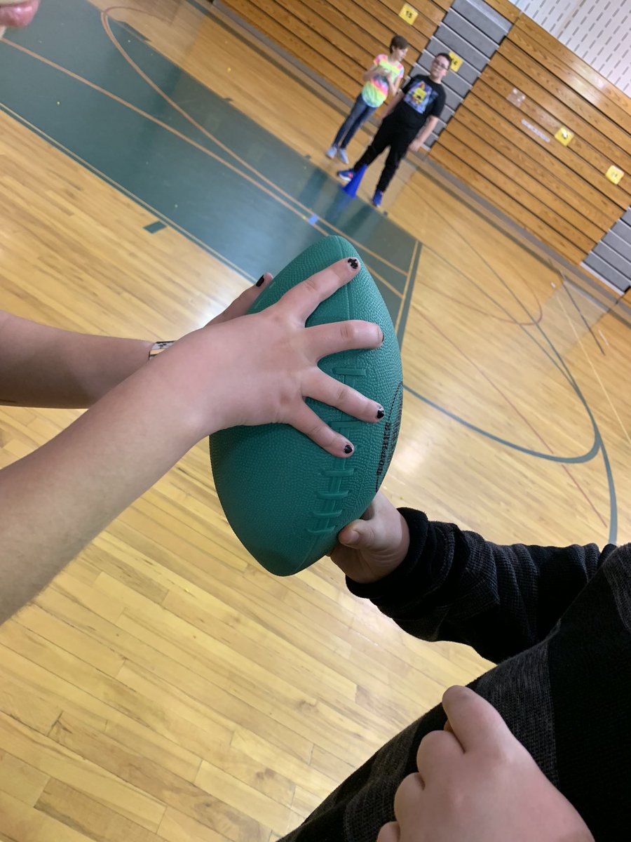 kierclass's tweet image. Aiden showed the class how to hold and throw a football. He also set up stations for students to warm up and stretch. Nice job Aiden! #thirdatbis