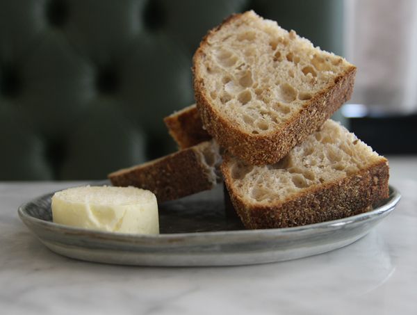 Don't overlook our heritage grain bread, baked fresh by our baking team and served with housemade cultured butter.