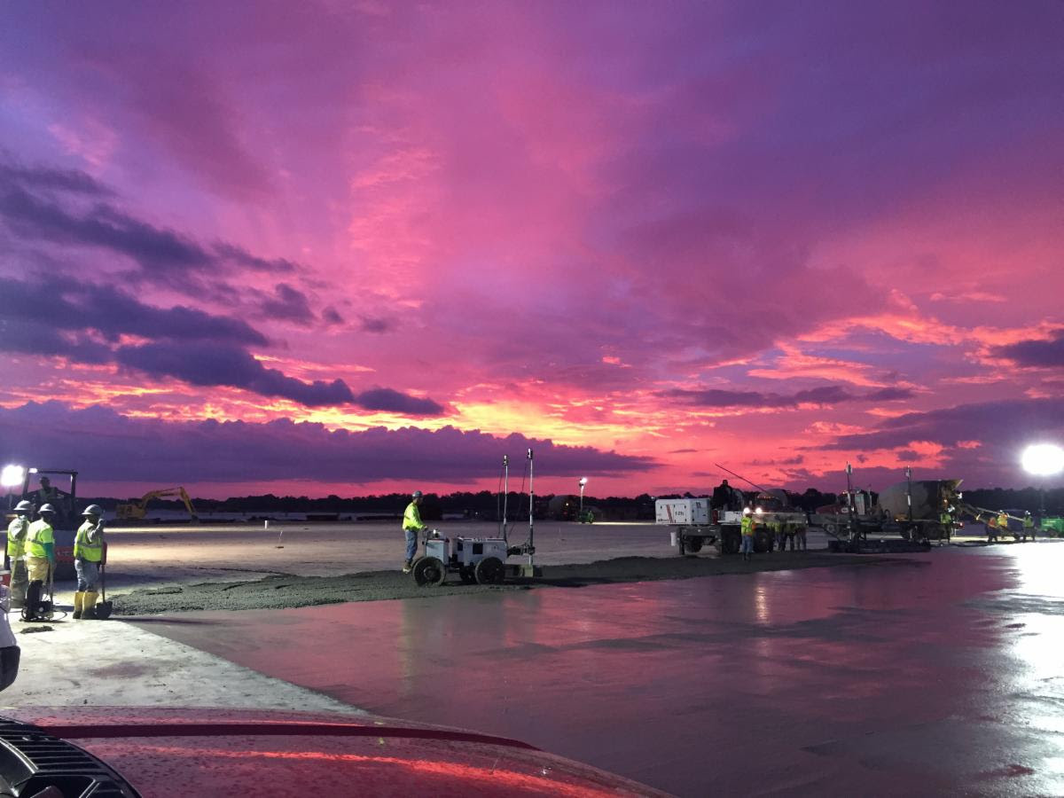 Salt flats? Expansive lake? Wet concrete, actually—2.5 million square feet of it. Shoutout to the
folks out there building every day at the crack of dawn. And a special shoutout to Johnny Hadden of
Building &amp; Earth for this beautiful sunrise pic.