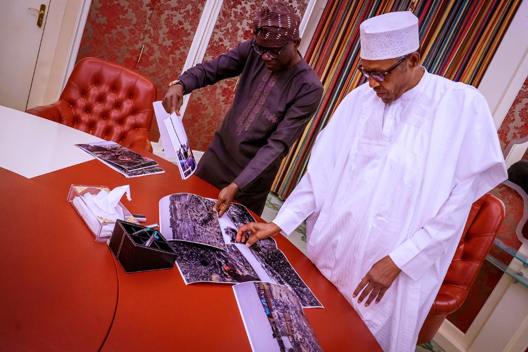 MobilePunch's tweet photo. PHOTOS: Governor Babajide Sanwo-Olu takes pictures of Lagos explosion to the President, Major General Muhammadu Buhari (retd.) in Aso Rock.
#festac #abuleadoexplosion https://t.co/Fdr7s6gOgo