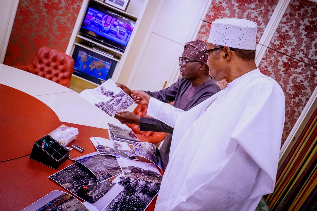 MobilePunch's tweet photo. PHOTOS: Governor Babajide Sanwo-Olu takes pictures of Lagos explosion to the President, Major General Muhammadu Buhari (retd.) in Aso Rock.
#festac #abuleadoexplosion https://t.co/Fdr7s6gOgo