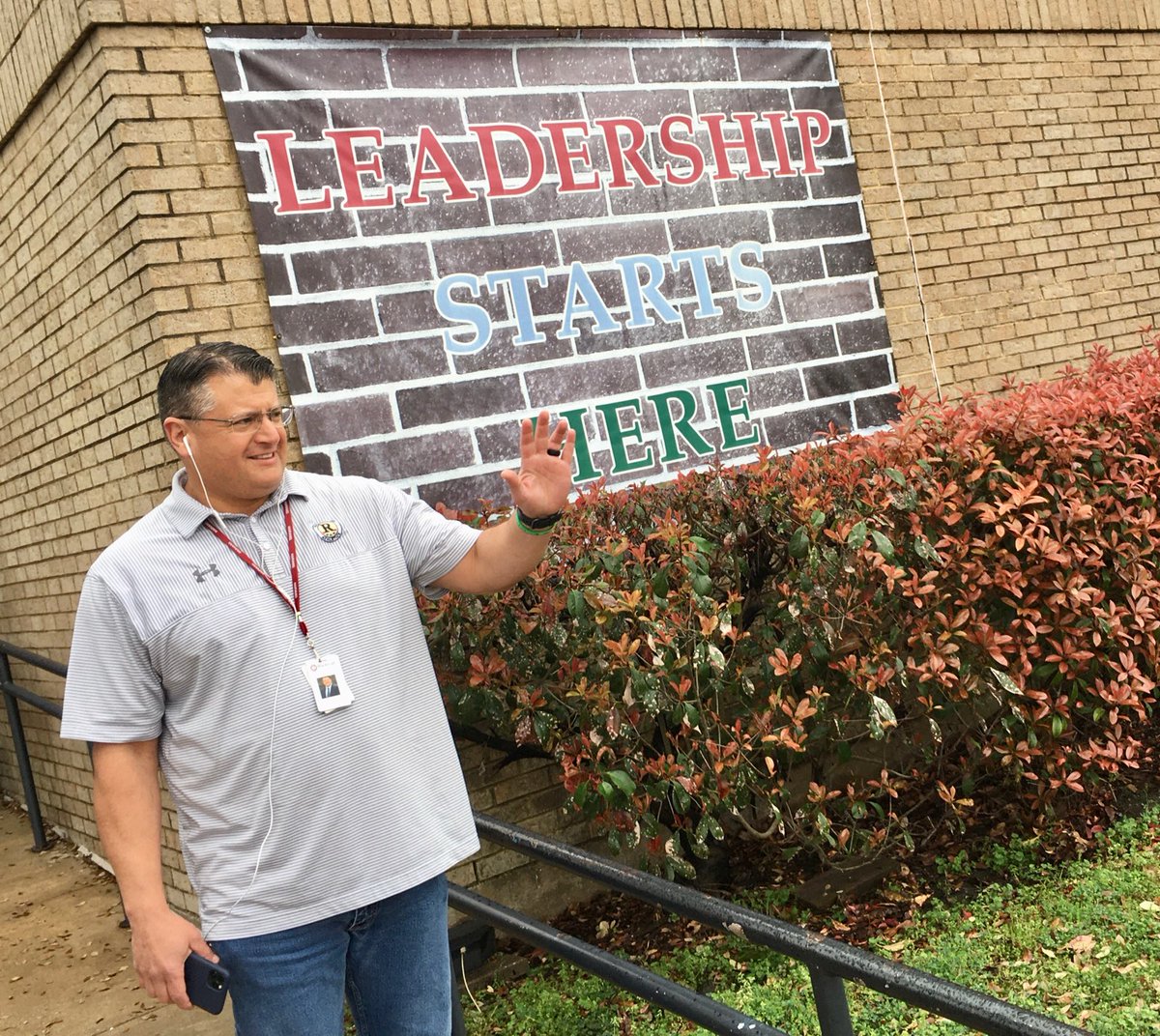 Dr. V waves to families in line for student meals this morning at Rochell ES while he listens to the TEA Commissioner's daily update.