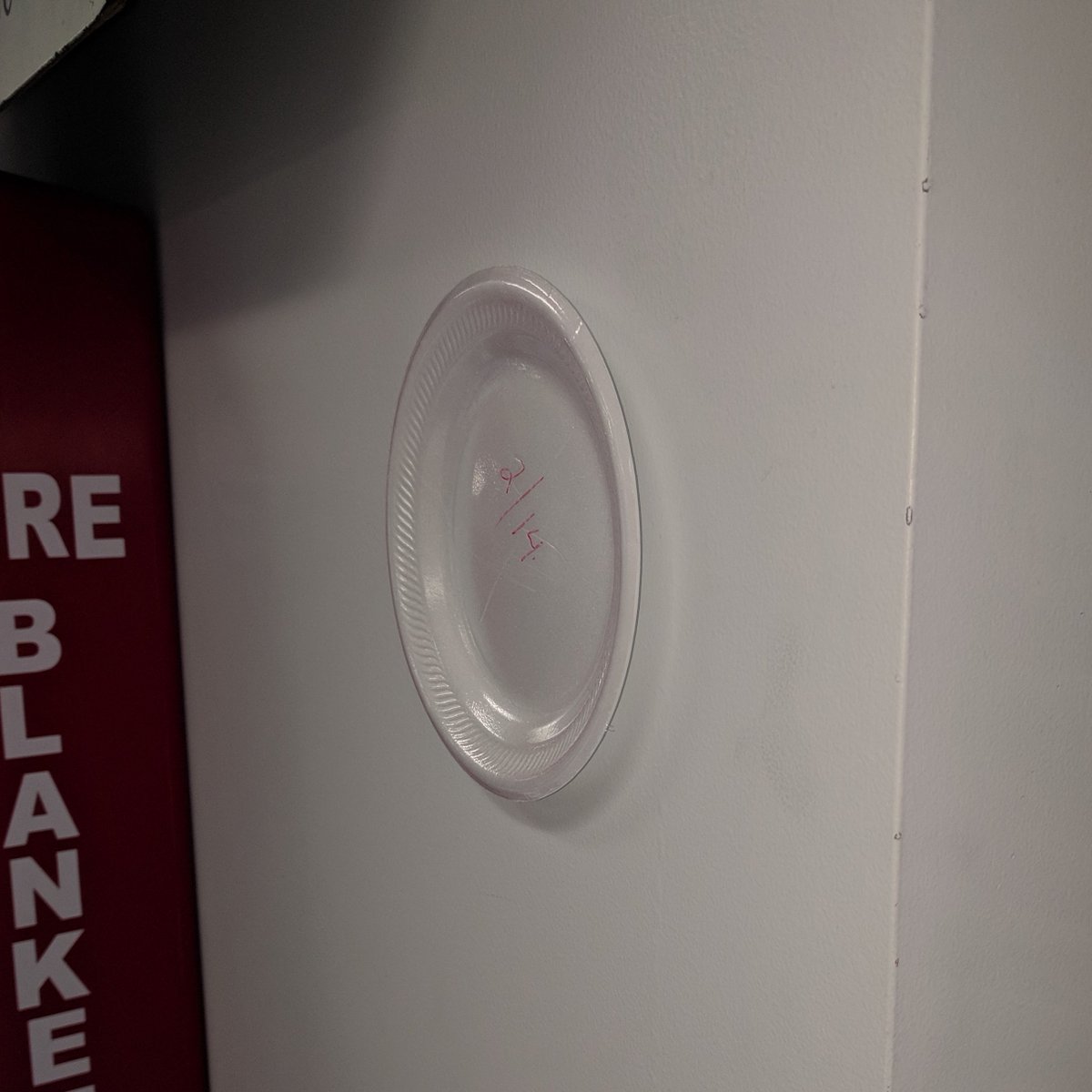 EAHSphysics's tweet photo. On Valentine's Day, 31 days ago, this plate was stuck to the wall with nothing but static electricity. No tape, no glue, just charge. It's still there. Not even COVID-19 can bring this plate down. I'll update when we return....See you soon! #StayCharged https://t.co/82GDj9DSXn