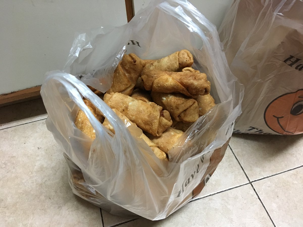 A plastic bag containing 48 egg rolls.