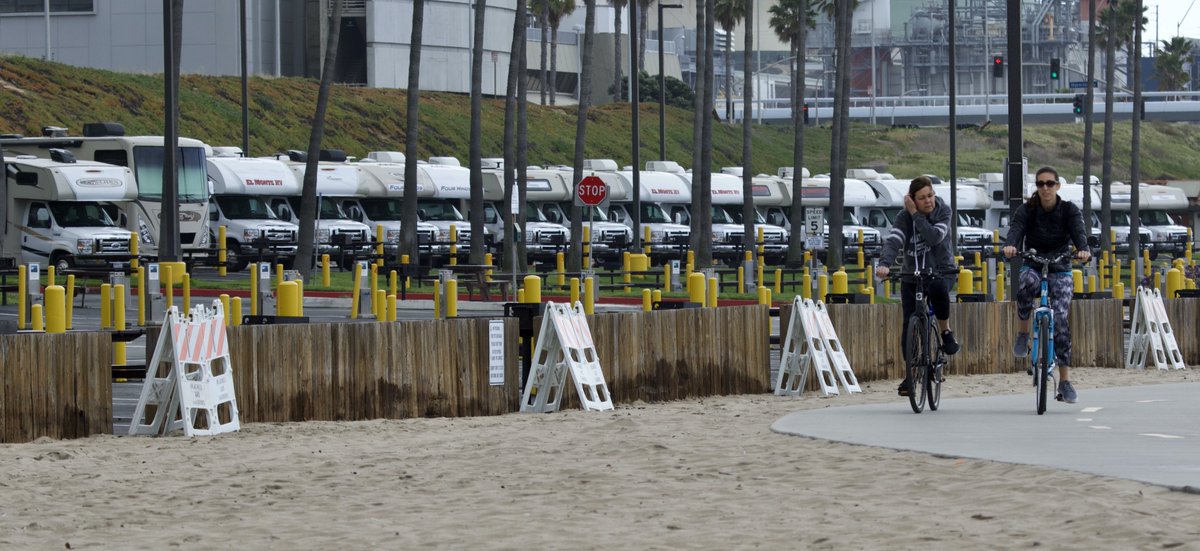 ShorealoneFilms's tweet photo. Cyclists pass by dozens of empty RVβs that will house #coronavirus patients for quarantine here at #DockweilerBeach in #PlayaDelRay 03-16-20 1 https://t.co/2rUfhruLMA