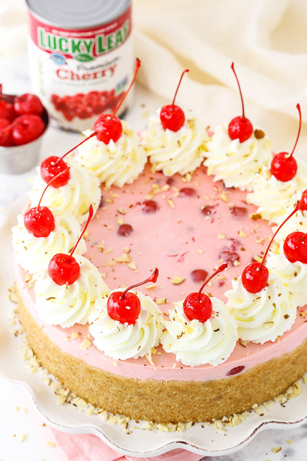 No Bake Cherry Almond Cheesecake! A vanilla cookie crust with layers of almond and cherry cheesecake made with <a href="/LuckyLeaf/">Lucky Leaf</a> fruit filling! Perfect for spring! lifeloveandsugar.com/no-bake-cherry… #ad #cheesecake #cherry #almond #nobake #recipe