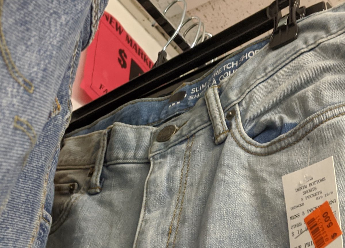All the jeans are different, so they weren't mass manufactured. Looking closely, the tags are either blacked out, or large enough to cover the original tag. These are used jeans that have been shipped from the USA to a factory overseas, turned into jean shorts, and shipped back.