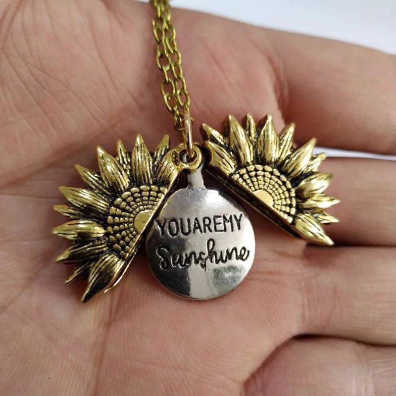 rakilstormi's tweet photo. My boyfriend got me this sunflower necklace that opens up to say you are my sunshine 🌞😍 I'm so in love🥰💛 https://t.co/YwRZKbAbTd