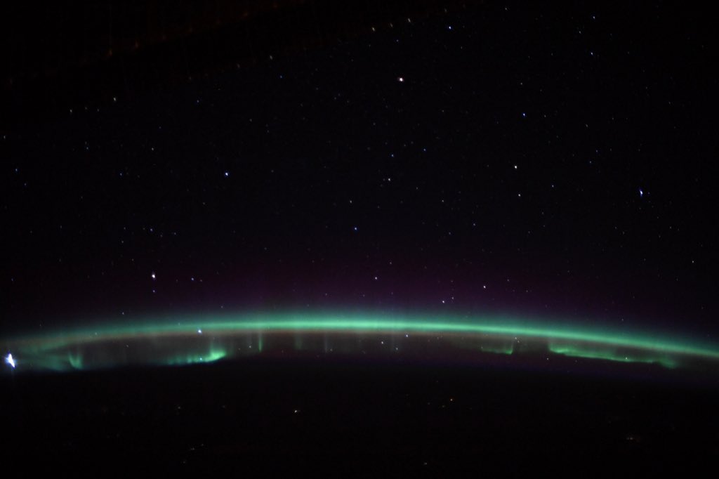 Astro_Jessica's tweet photo. Even the atmosphere is excited and proudly glowing green for #StPatricksDay – started experimenting this week with my first aurora borealis (northern lights) shots on @Space_Station . . . stay tuned! https://t.co/qtdIAoE36M