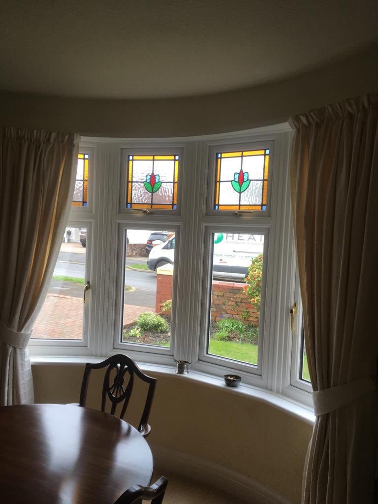 Heathwindows80's tweet photo. Lovely retained original stained glass from 1930’s in new upvc windows installed in Penarth. #retainedstains #encapsulatedstainedglass #stainedglass #penarth #upvcwindows #windows https://t.co/fzsFaMpqbm