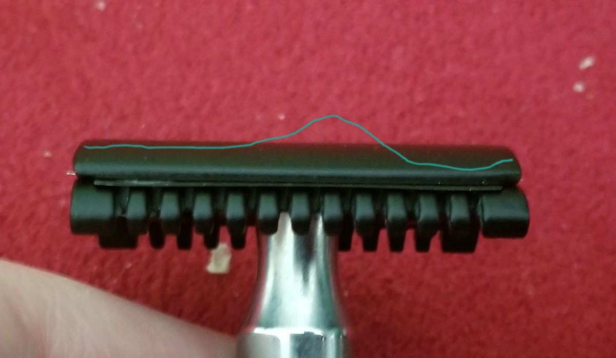 The black west coast shaving head I put on the handle for the $80 brand I have, warps the blade terribly with a sizeable bump in the middle, while the cheap barber supply razor with a chrome head holds the blade straight