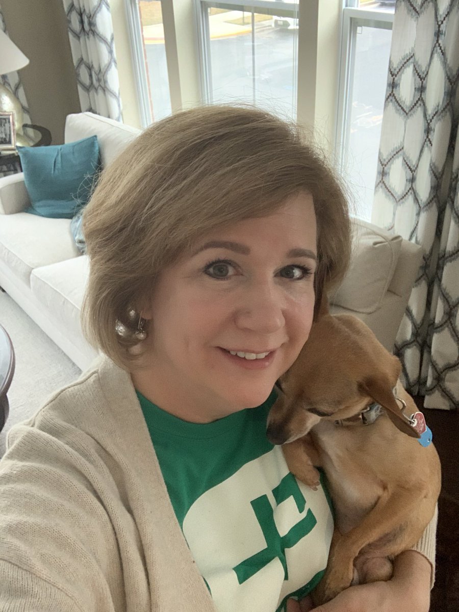 Wearing spirit wear. Although Buddy is the right size, he is not a stuffed animal and not happy about being in the photo.