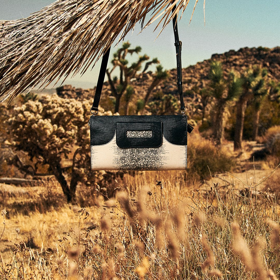 The two-tone python clutch BORA won't leave you hanging! Now available at annefontaine.com