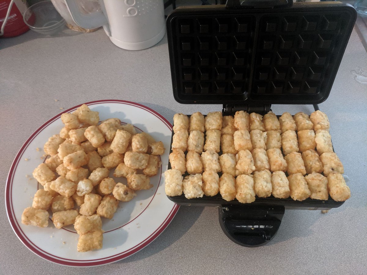 Once you've prepped your tots, line them up on the waffle iron. Wherever they go, really. Tear them to make them fit small holes. Squish them into place. It doesn't matter. They are potatoes, and they will do your bidding.