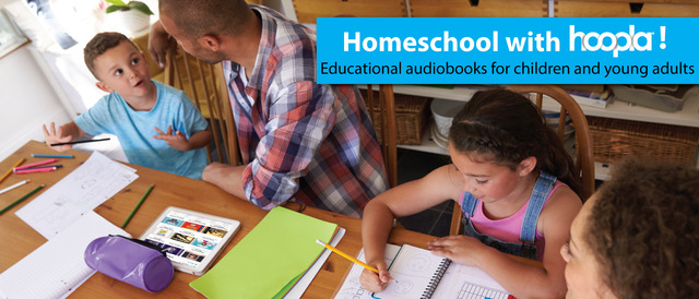 a photograph of a man and a woman sitting at a table with children as the kids draw