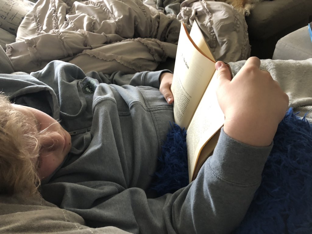 Reading time at home this morning.. Tyler totally fell asleep. It looks like he’s reading but I can hear the snores. 😂🤣😂
