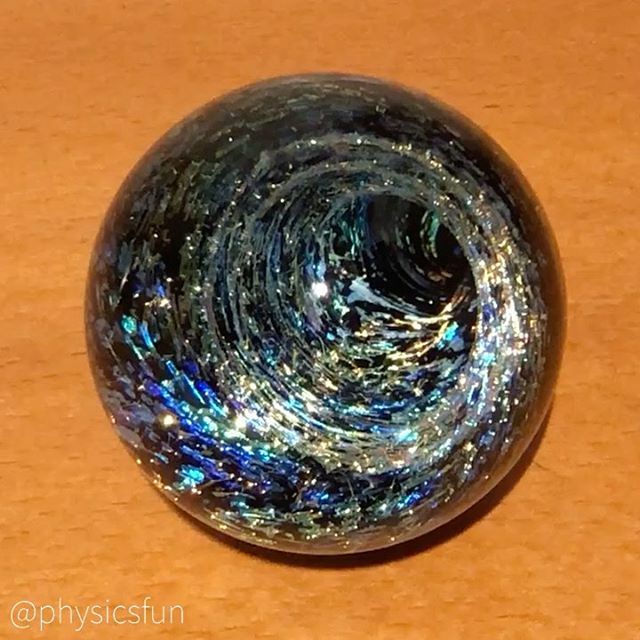 PhysicsfunE's tweet photo. Vortex Marble: glass art intersects with the physics of optics in this lampwork art form invented by Kevin O’Grady circa 1994- and this marble bears his signature mark on the back. The clear glass face on these marbles acts as a convex lens giving the il… https://t.co/rQJmxUQZ78 https://t.co/mI8IO7TTLi