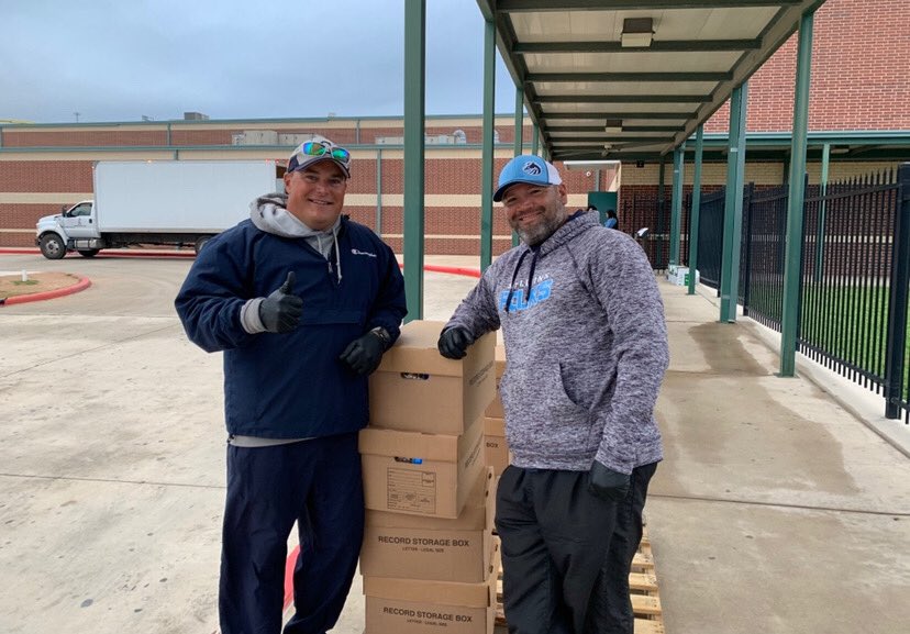 NISDFolks's tweet photo. Folks coaches, Coach Lambert and Coach Juarez, going #beyondthegame to help NISD distribute food to  NISD families! #thisisfolks #NISDLegends https://t.co/5LuAhtYjmD
