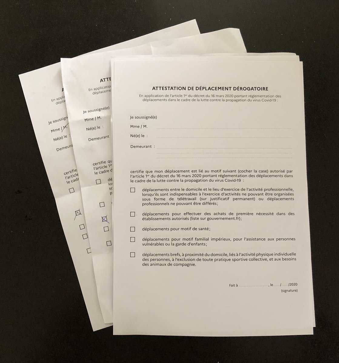 PedderSophie's tweet photo. The new normal in France. Day 5 of confinement. These are permission forms lying ready in our kitchen. 5 options to tick if you want to go out: essential work, shop for necessities, medical needs, help the fragile, or walk dog/local run. Police regularly check papers on street https://t.co/B7tRIZy0yI