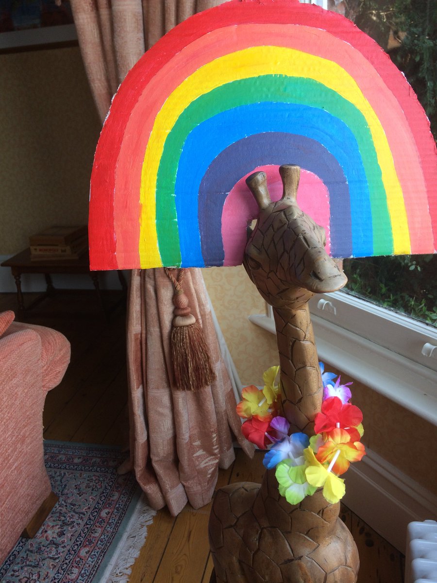 In Alcester we're putting rainbows in our windows to cheer up local children going for a walk, thank you art student daughter <a href="/Izzywoww/">iz</a> for making Gerald the giraffe a rainbow hat <a href="/AlcesterTown/">Alcester Town</a>