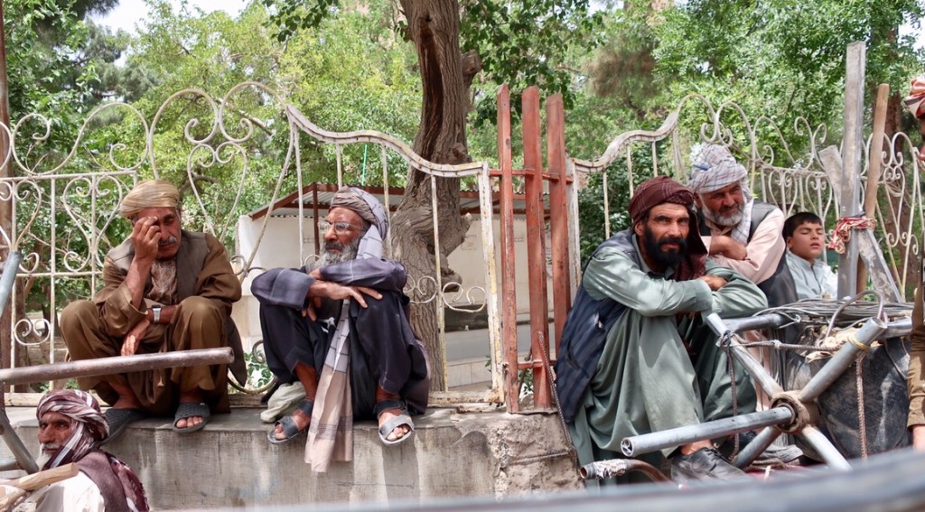 People of Herat: wheelbarrow men waiting for work.Unknown artist.
