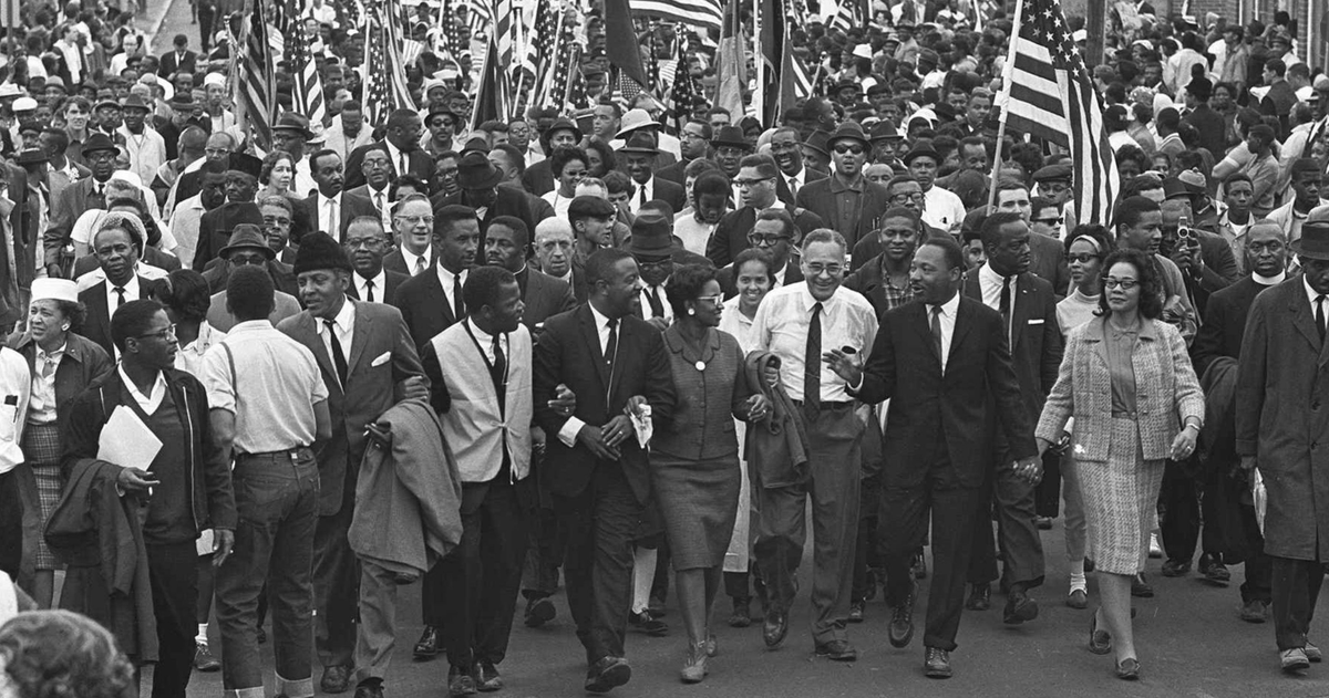 Marchers are seen walking from Selma to Montgomery, Alabama to demand voting rights. Dr. Martin Luther King, Jr. and Coretta Scott King are in the front line of marchers.