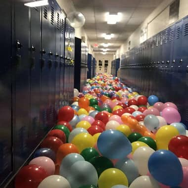 A teacher brought balloons to school and asked the children to blow them all up and then each write their names on their balloon.They tossed all the balloons into the hall while the teacher mixed them from one end to the other.