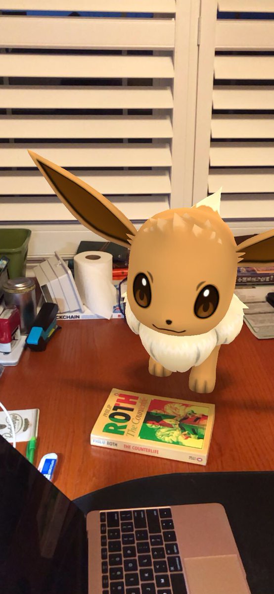 IWDL_Writer's tweet photo. My #eevee Mickey, reading and critiquing Roth with me. Lol who knew he was this kind of reader? #arphotography #pokemongo #philiproth #ultimatecrossover #pkmngo https://t.co/3bJ3GOkYDQ