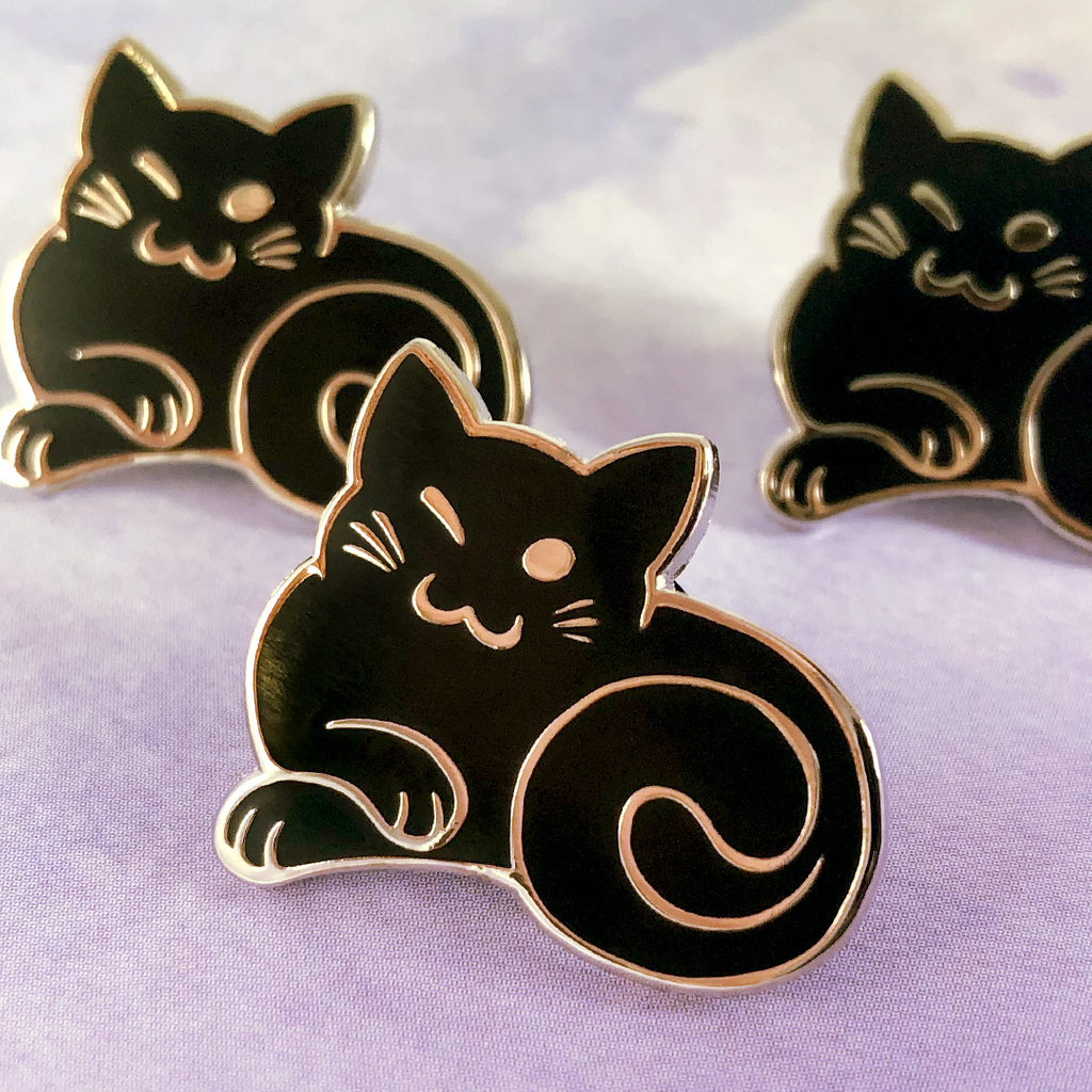 Some adorable winking kitty pins we produced for <a href="/DAPshow/">DAPshow</a>! You can pick one up for yourself here: shop.dapshow.com/collections/al…

If you are interested in turning your own designs into enamel pins, get a quick quote right on our site to get started!
stadriemblems.com/shop/custom-en…