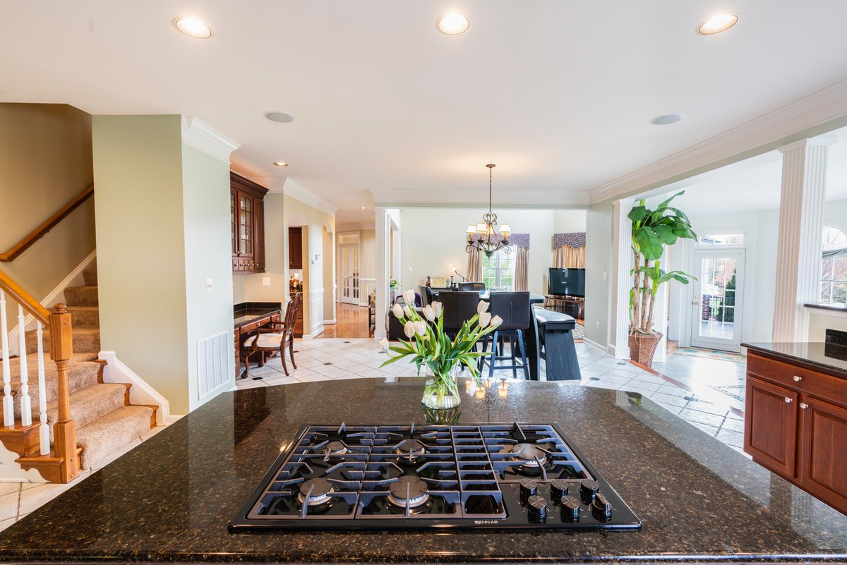 Adding some freshly-cut flowers to your #countertops is a great way to add a little outdoor energy while you're cooped up at home. #kitchencounters #kitchencountertops #countertopideas #kitchenisland #homedesign #homedecor #homereno #unsplash #instahome