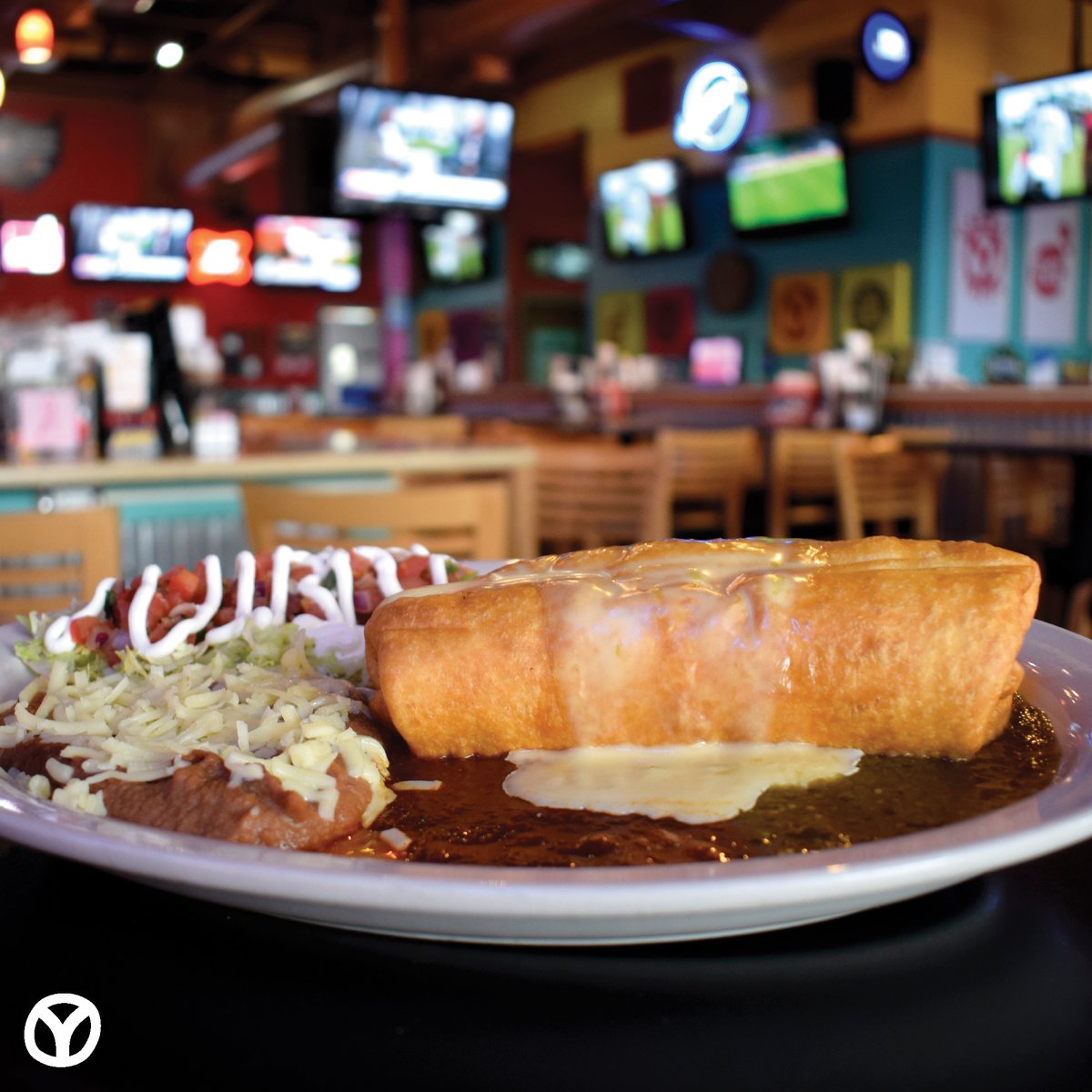 Hungry? Try our Chimichanga. Your choice of protein, our baja rice &amp; cheese, wrapped up and deep fried, then topped with our house rojo, green chili sauce AND queso. Served with our refried beans, lettuce, pico and sour cream.