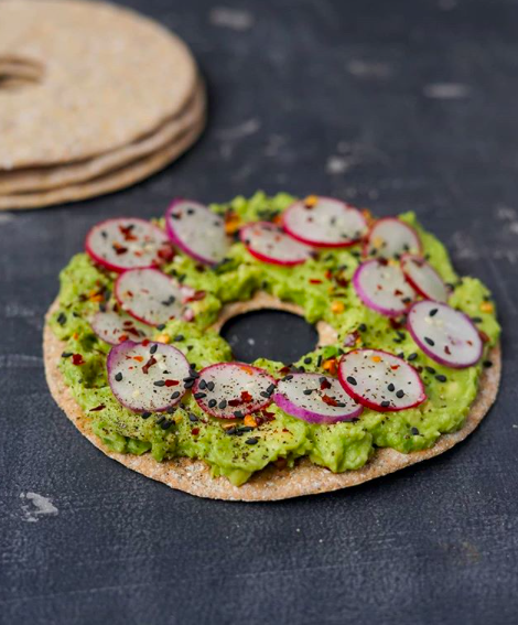 Swap your bagel for one of our Original sourdough crispbreads this lunch - they're high in fiber, low in sugar and only 75 calories per piece. Top them with smashed avocado, sliced radish, sesame seeds and chilli flakes for a delicious and nutritious lunch #workingfromhome