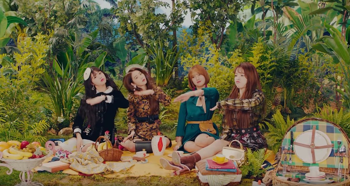 Banana Allergy Monkey (cont.):In the jungle scene, you can see bananas growing on the trees. The girls having a picnic are displaying several fruits including bananas, oranges, mangoes, yellow grapes, red grapes, and strawberries. Seunghee also pulls a banana from her purse.