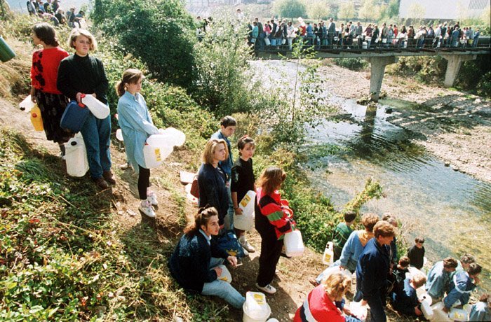 Residents of Sarajevo stand in line to get water, 1992. [ Mikhail Evstafiev]