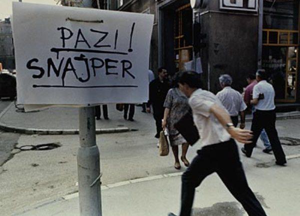 Signs reading Pazite, Snajper! ("Beware, Sniper!") became commonplace and certain particularly dangerous streets, most notably Ulica Zmaja od Bosne, the main street which eventually leads to the airport, were known as "sniper alleys." AP Photo/Michael Stravato