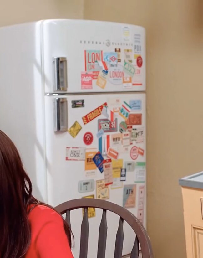 the stickers on the refrigerator show paris (heejin's location) and london (where the carol was filmed).
