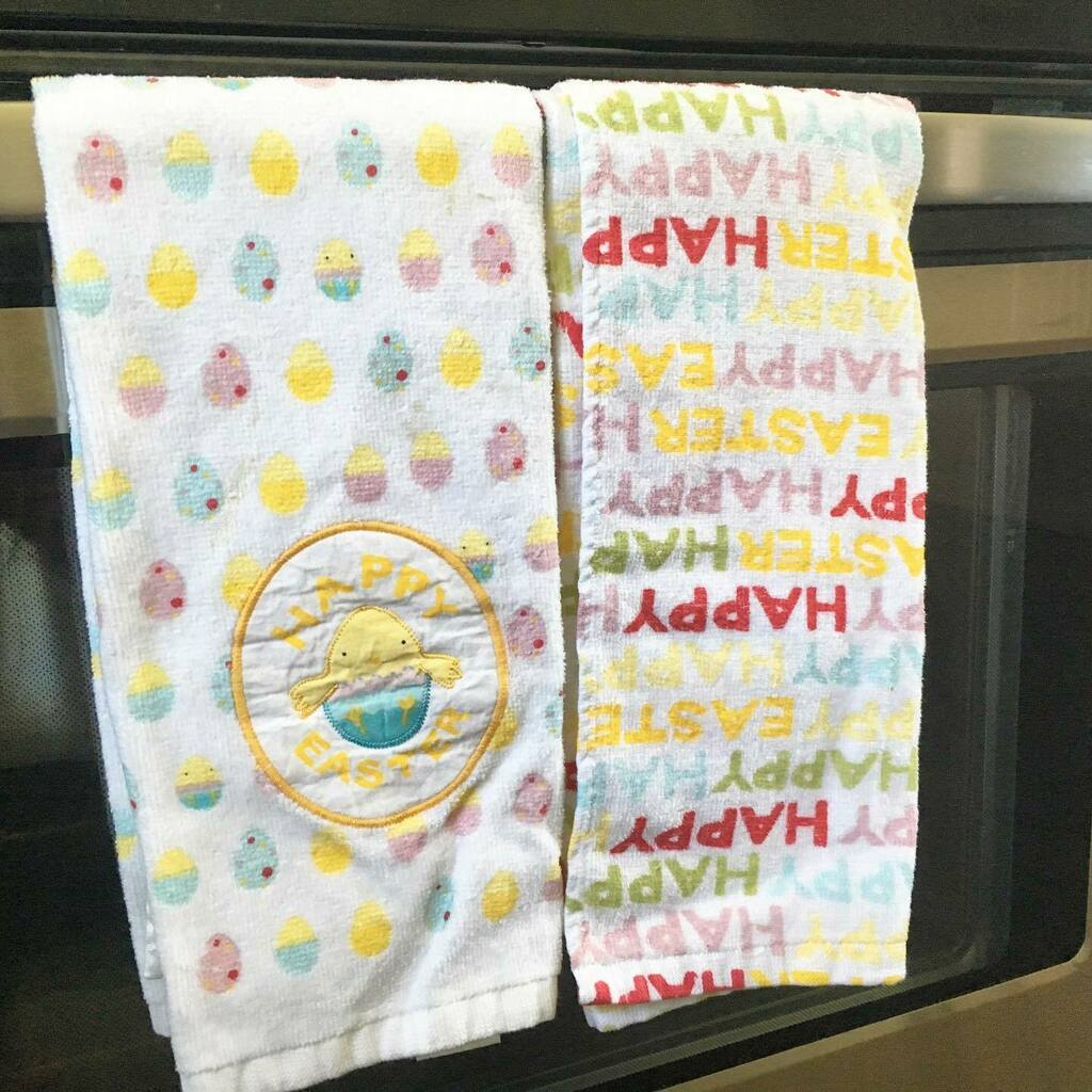 Two Easter towels on an oven.