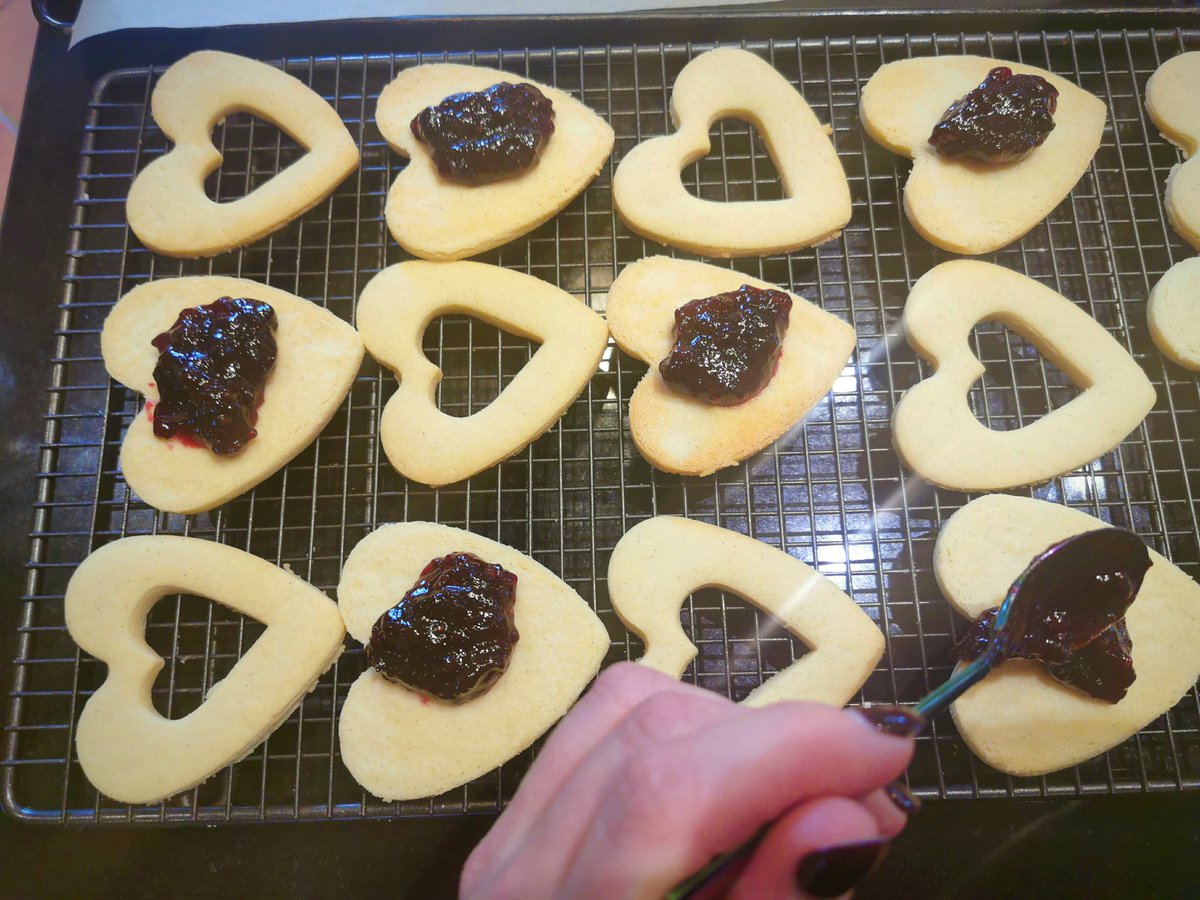 When your biscuits have cooled down and firmed up a bit, put a nice blob of jam in the middle of each of the base pieces, and then carefully put the top bit on. Sprinkle the jammed and sandwiched biscuits with Caster sugar.
