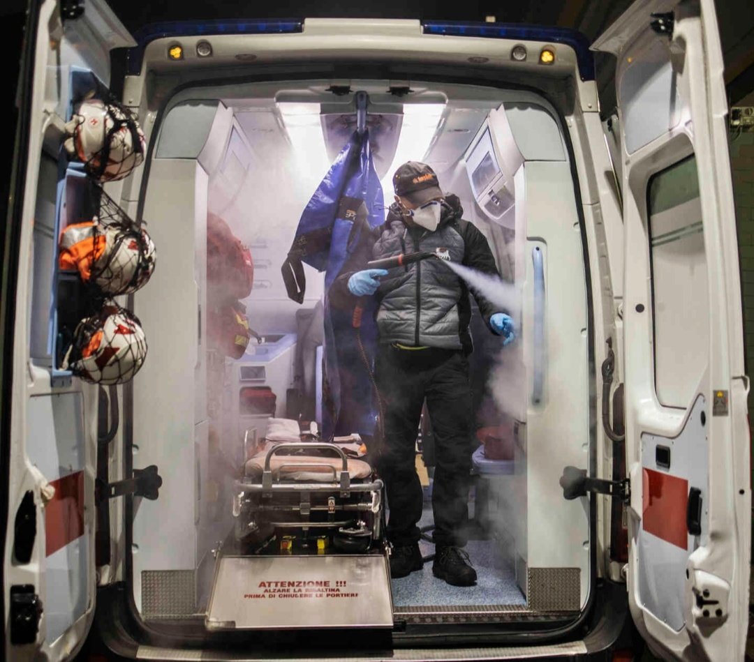 Red Cross workers disinfect the ambulance and themselves. Hospitals were no longer safe as people would probably get infected from there.