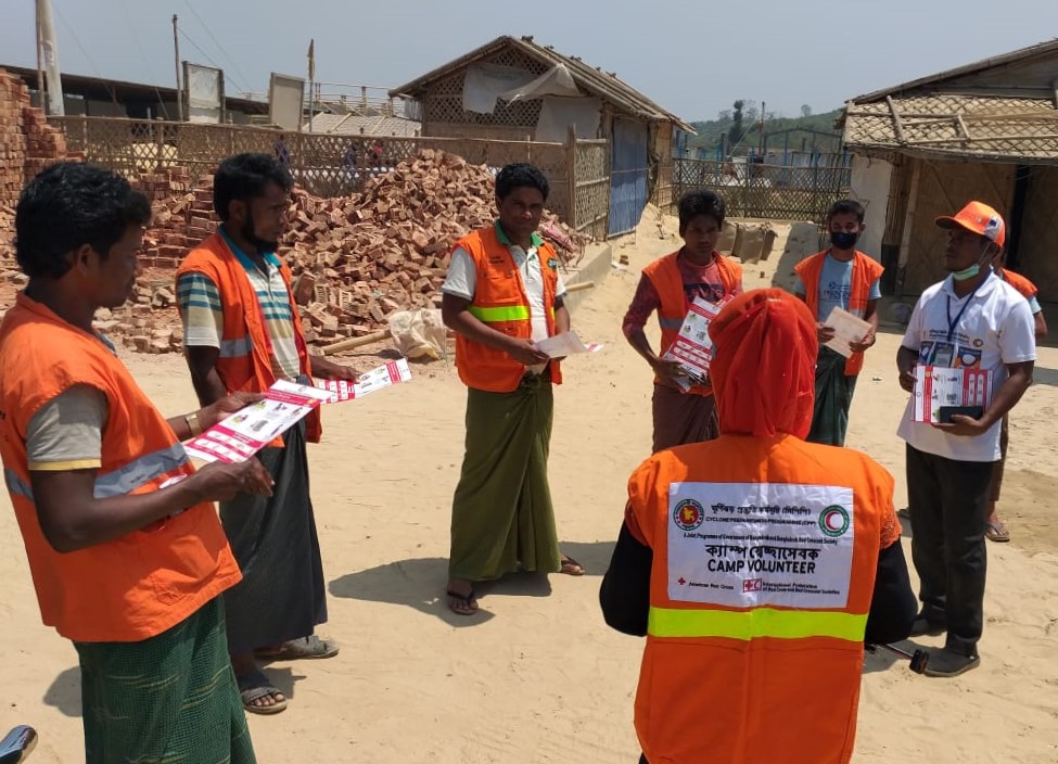 BDRCS1's tweet photo. #InformationIsAid. #Bangladesh #RedCrescent, along with Govt., re-purposed their joint Cyclone Preparedness Programme (CPP) Camp Volunteers to raise awareness on #coronavirus in #Coxsbazar camp area which has a population density of 40,000 people per sq. km. #LeaveNoOneBehind https://t.co/447F8Zv6l9