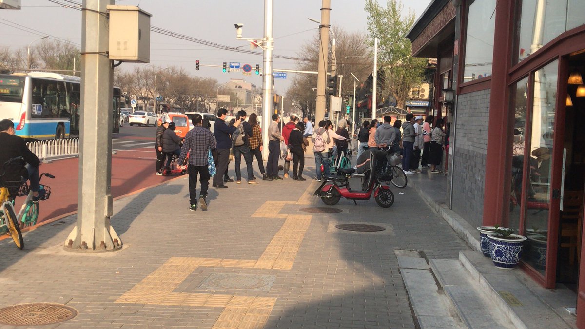 ...explain less traffic, but it still seemed brisk to me. There were people lining up to get into a local food shop (see left), something I hadn’t seen since January, and at the famous chestnut shop on the corner of my hutong it was almost like old times (see right), with 19...