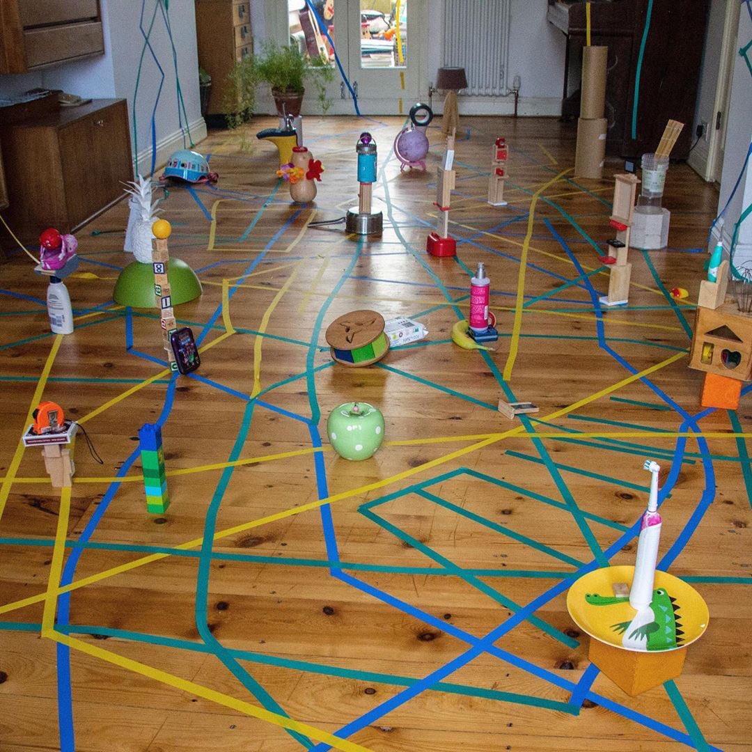 LeapThen's tweet photo. ‘Make a line and follow it.’ Drawing with tape, travelling along it and finding objects from around the house to place on the connections and make towers with. Why not try it at home? If you do tag us in your pics! 
#homeschool #artathome #tapeart #isolationart #lockdownart https://t.co/NF2XGHEKct