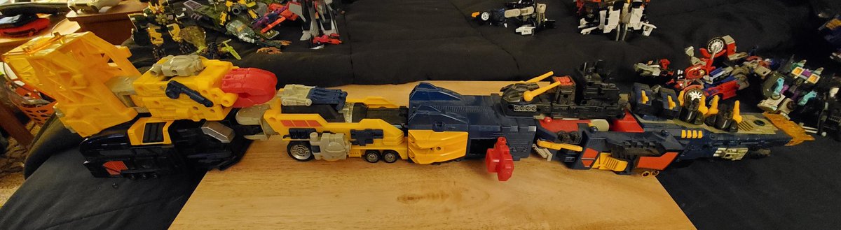 The crane... train... half, slots into the back of the battleship. Why? Because fuck you, it's OMEGA SUPREME.
