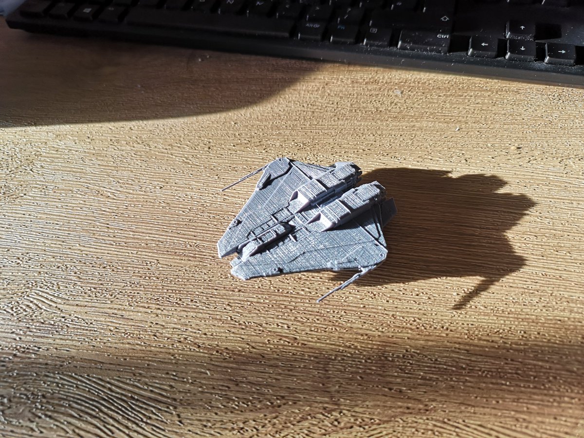 LacunaAspect's tweet photo. Finally got my little printer doing good things, here's a small Krait Mk2 in homage to my Milk Krait, to play with whilst working from home. Hoping to file down the ridges and paint her soon. #EliteDangerous @EliteDangerous #kraitmk2 #3Dprinting https://t.co/PmS2kxtRYW