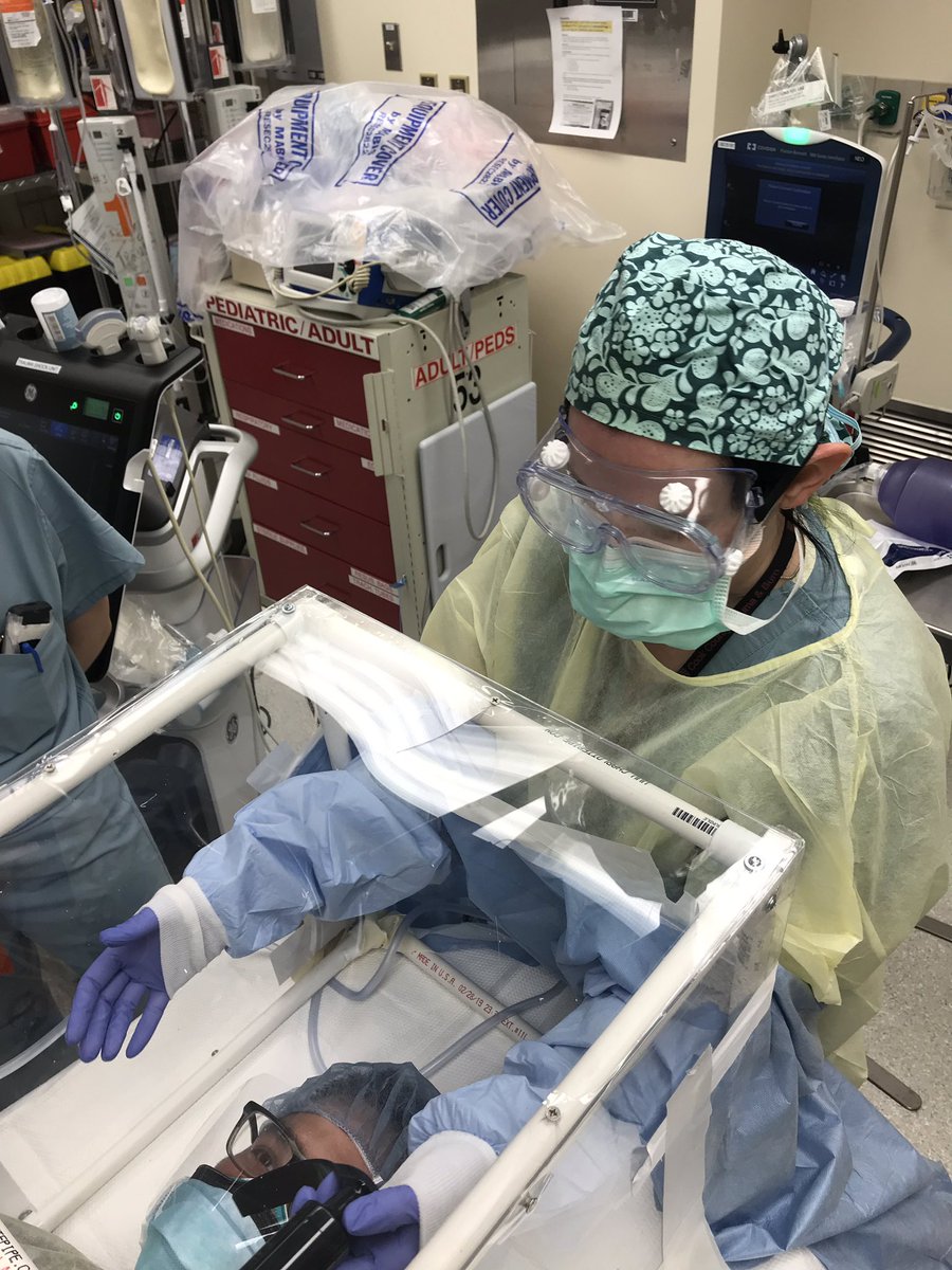 LeahTatebe's tweet photo. Simulation drills to hone and troubleshoot COVID intubation protocols in our trauma bay. I see the use of this, but as a surgeon it is very strange to purposely place a box between me and the neck #BackupPlans #OutsideTheBox #WheresMyKnife #ILookLikeASurgeon #NotAnERDoc https://t.co/gadJUqbm1v